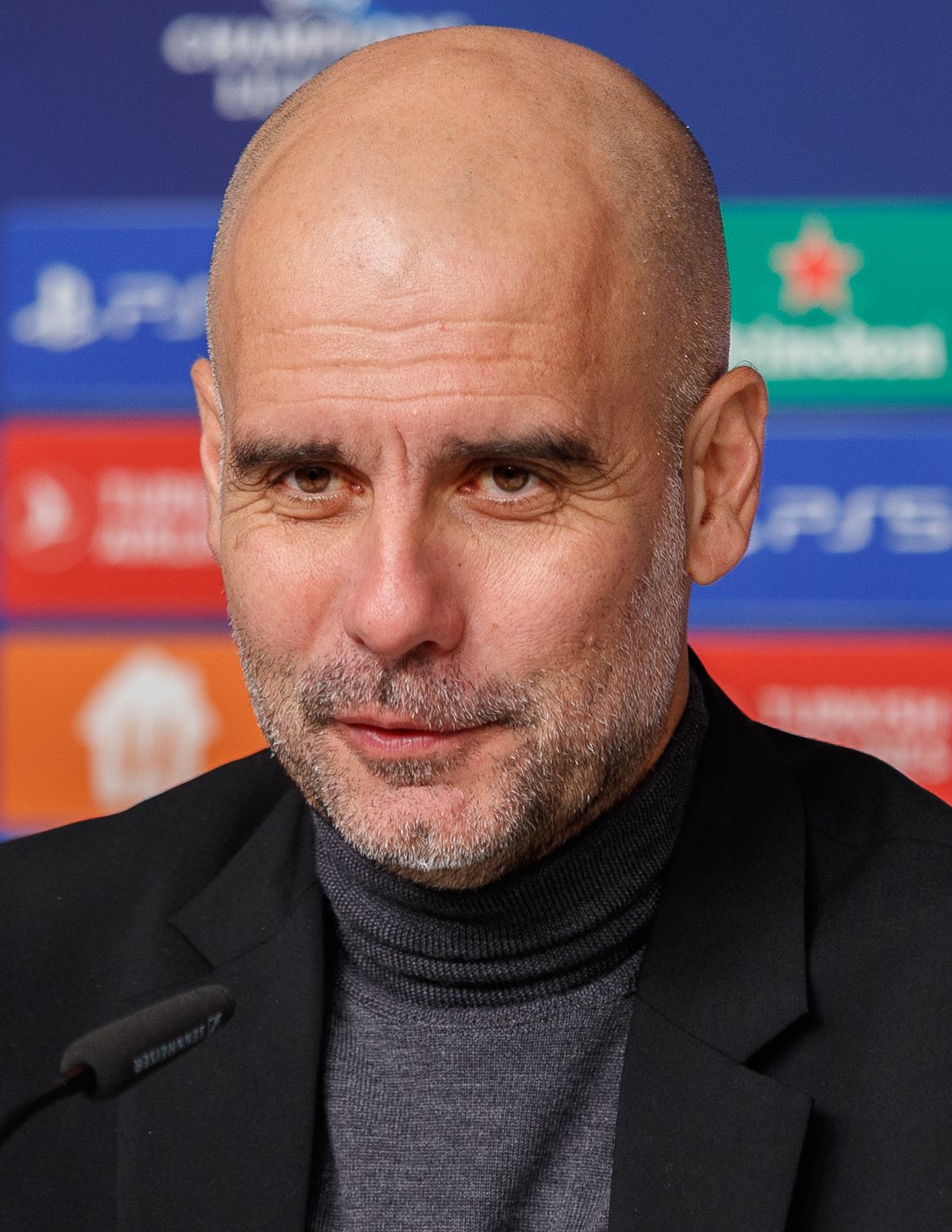 Pep Guardiola watching a football match from the touchline